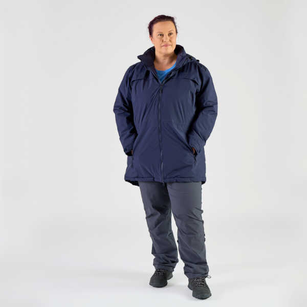 Person wearing a navy blue raincoat and pants on a white background