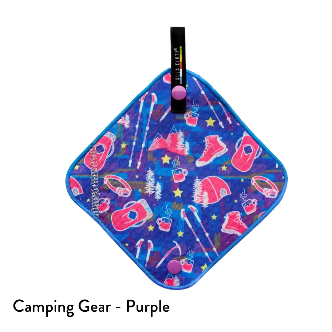 kula cloth pee cloth featuring colourful hiking equipment in pink and white, on a blue and multicoloured background, and a blue trim