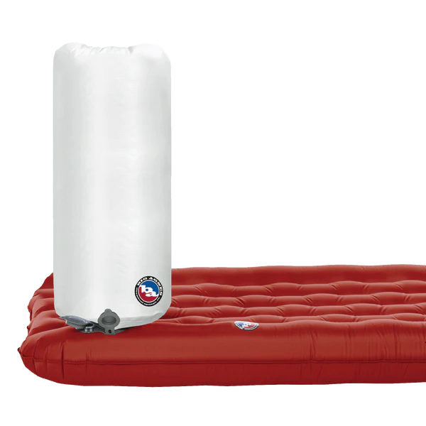 Red inflatable mattress with white pump on a white background